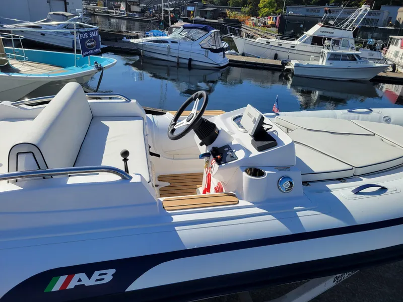Slide: The Image of 2021 AB Inflatables ABJET 430XP boat docked, featuring sleek design and modern controls. - 14
