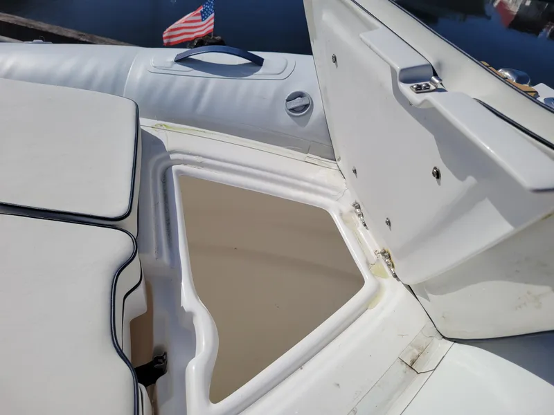 Slide: The Image of 2021 AB Inflatables ABJET 430XP boat storage compartment open, with American flag in background. - 25