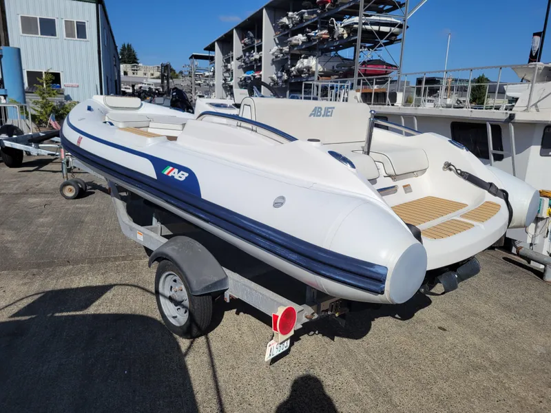 Slide: The Image of 2021 AB Inflatables ABJET 430XP on trailer, dockside, under clear blue sky. - 8