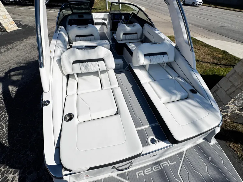 Slide: The Image of 2025 Regal LS4 boat with luxurious white seating and sleek design. - 10