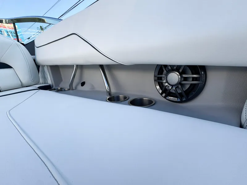 Slide: The Image of 2025 Regal LS4 boat interior with cup holders and speaker. - 14