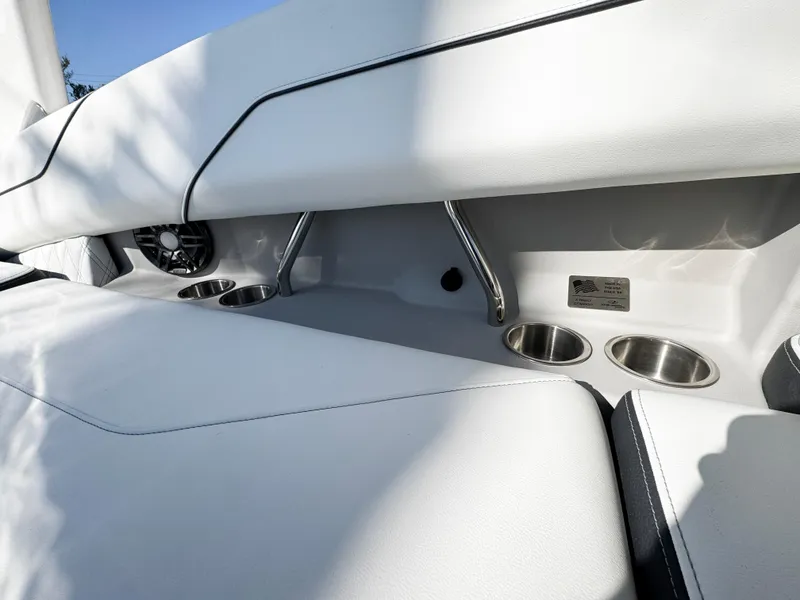 Slide: The Image of 2025 Regal LS4 boat interior with cup holders and speaker. - 17