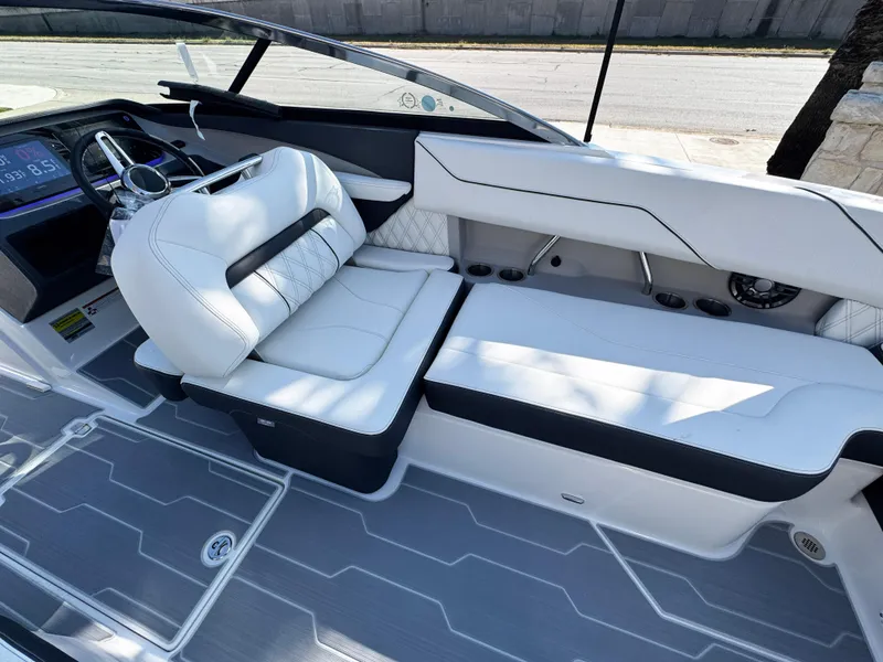 Slide: The Image of 2025 Regal LS4 boat interior with sleek white seating and modern dashboard. - 19
