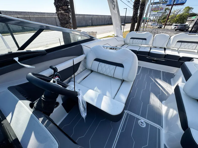 Slide: The Image of 2025 Regal LS4 boat interior with modern seating and steering wheel. - 21