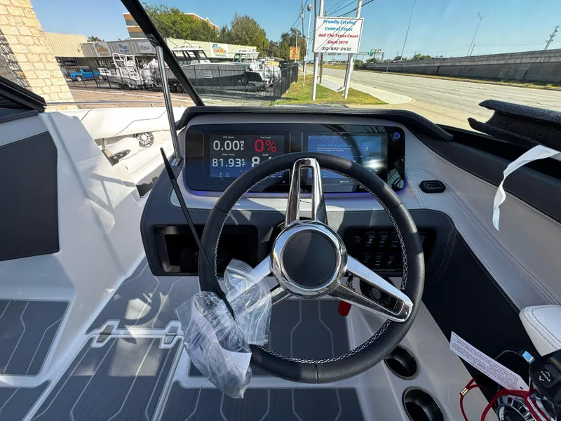 Slide: The Image of 2025 Regal LS4 boat dashboard with modern steering wheel and digital display. - 23