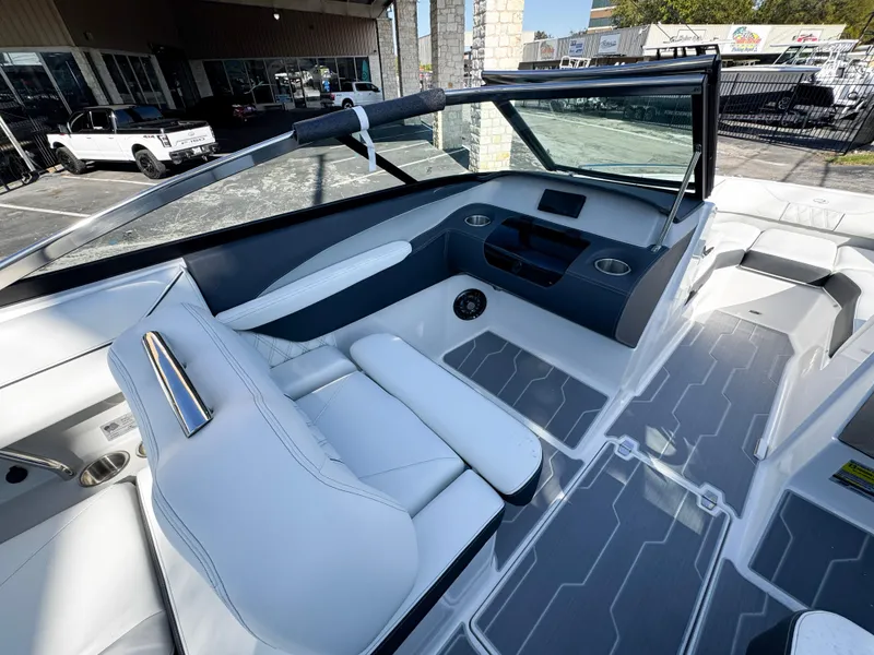 Slide: The Image of 2025 Regal LS4 boat interior with sleek white seating and modern dashboard design. - 25