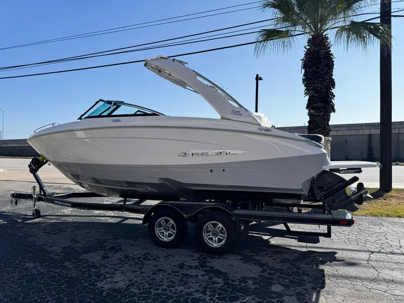Slide: The Image of 2025 Regal LS4 boat on trailer, parked outdoors under clear sky. - 3