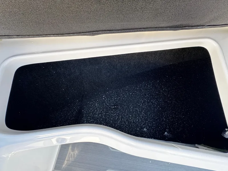 Slide: The Image of 2025 Regal LS4 boat storage compartment with black interior lining. - 35