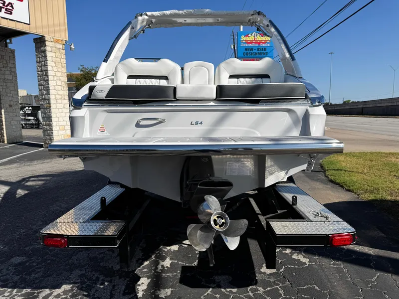 Slide: The Image of 2025 Regal LS4 boat rear view with propeller and trailer in parking lot. - 5