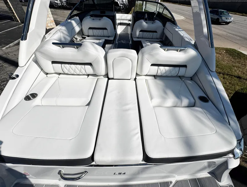 Slide: The Image of 2025 Regal LS4 boat with luxurious white seating and sleek design. - 8