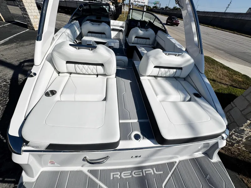 Slide: The Image of 2025 Regal LS4 boat with luxurious white seating and sleek design. - 9