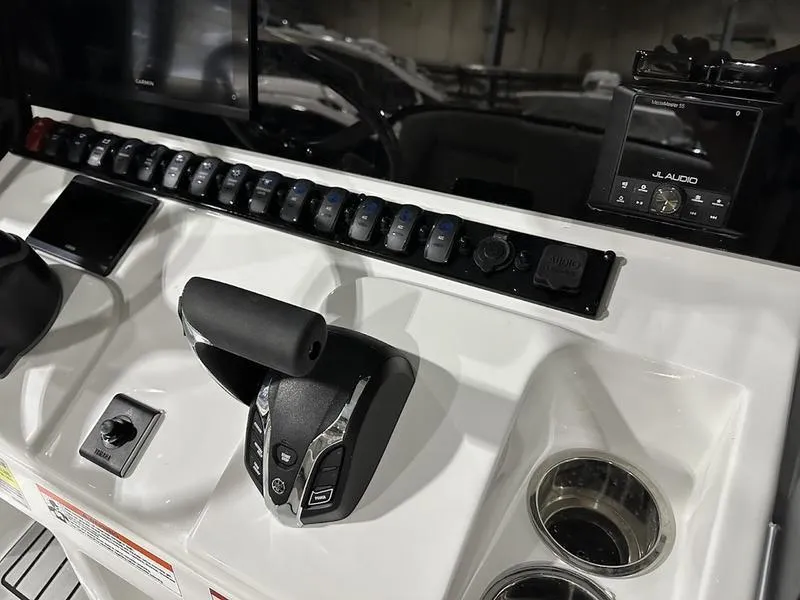 Slide: The Image of Control panel of 2025 Sea Hunt Ultra 239se boat with throttle and switches. - 11