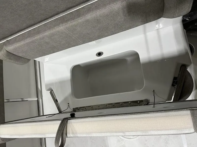 Slide: The Image of 2025 Sea Hunt Ultra 239se boat interior with storage compartment. - 13