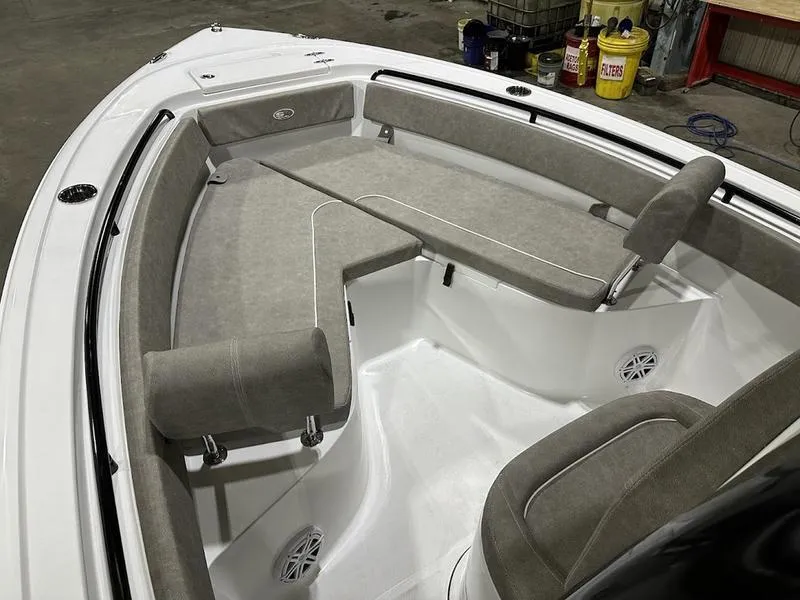 Slide: The Image of 2025 Sea Hunt Ultra 239se boat interior with cushioned seating and speakers. - 16