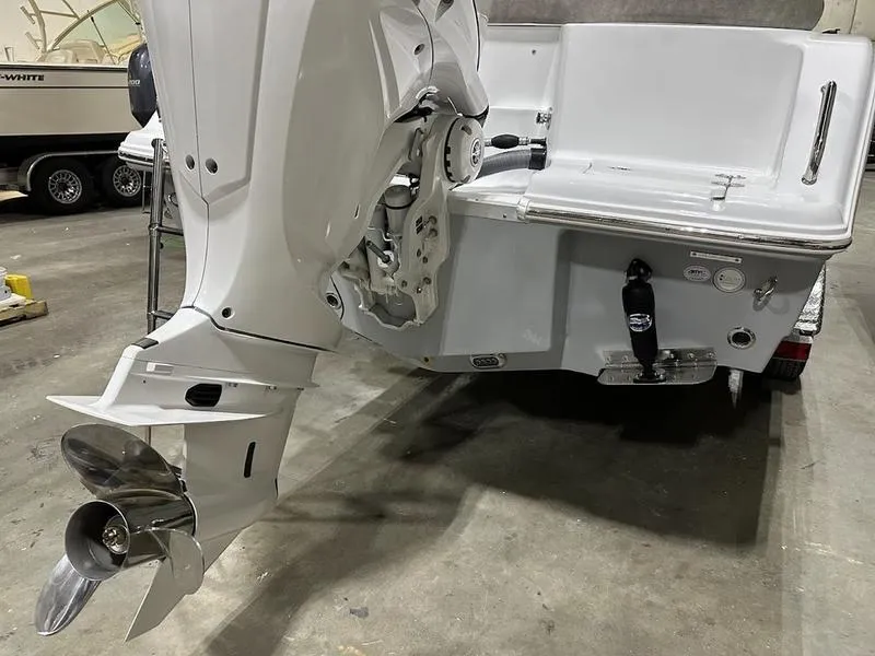 Slide: The Image of 2025 Sea Hunt Ultra 239se boat engine and propeller in a garage. - 3