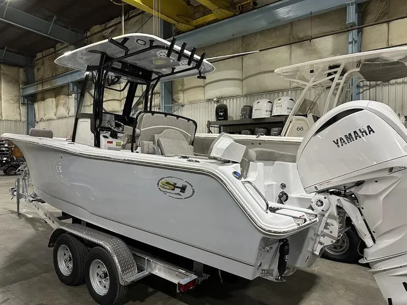 Slide: The Image of 2025 Sea Hunt Ultra 239se boat with Yamaha engine in a warehouse. - 4