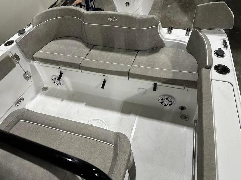 Slide: The Image of 2025 Sea Hunt Ultra 239se boat interior with gray cushioned seating and white deck. - 5