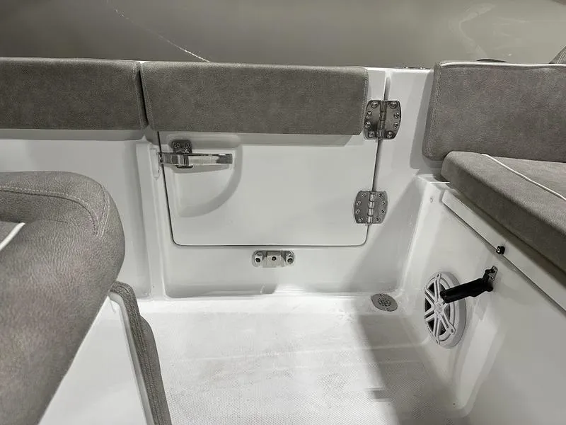Slide: The Image of Interior of 2025 Sea Hunt Ultra 239se boat, featuring cushioned seating and storage compartment. - 7