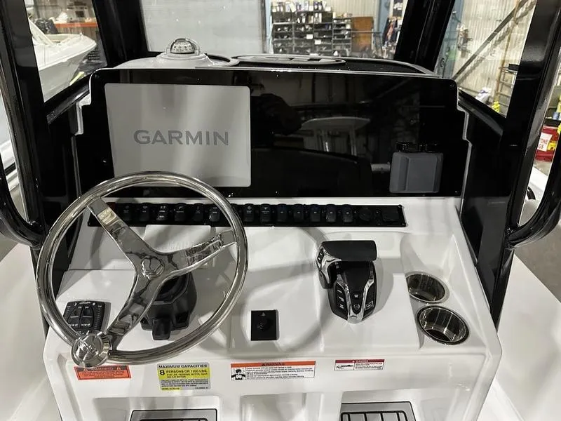 Slide: The Image of 2025 Sea Hunt Ultra 239se boat dashboard with Garmin navigation system and steering wheel. - 8