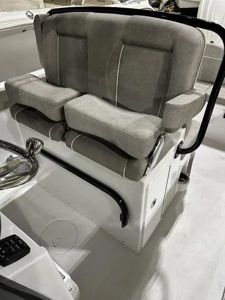 Slide: The Image of 2025 Sea Hunt Ultra 239se boat seating with gray cushions and black railing. - 9