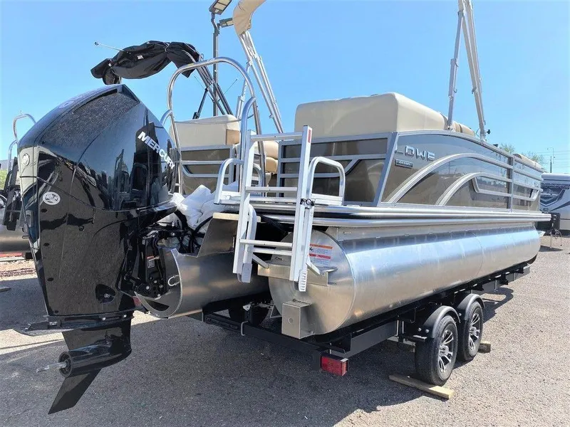 Slide: The Image of 2022 Lowe SS 230 WT pontoon boat with Mercury outboard engine on trailer. - 2