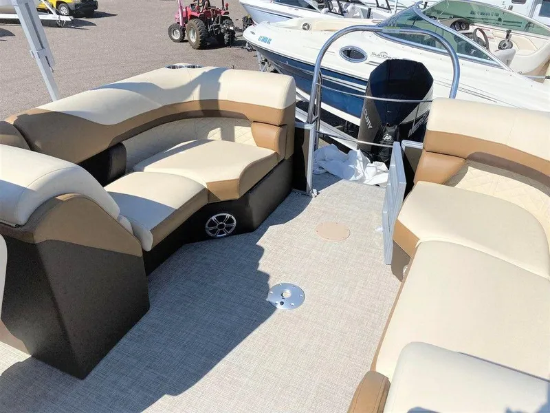 Slide: The Image of 2022 Lowe SS 230 WT pontoon boat interior with beige seating and carpeted floor. - 4