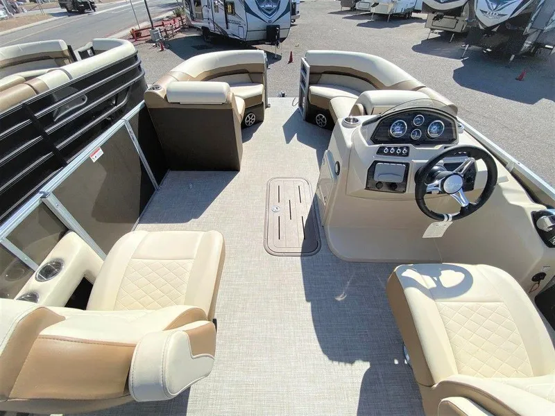 Slide: The Image of 2022 Lowe SS 230 WT pontoon boat interior with beige seating and steering console. - 6