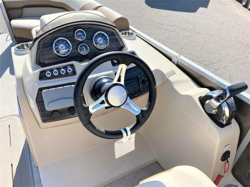 Slide: The Image of 2022 Lowe SS 230 WT boat dashboard with steering wheel and control panel. - 7