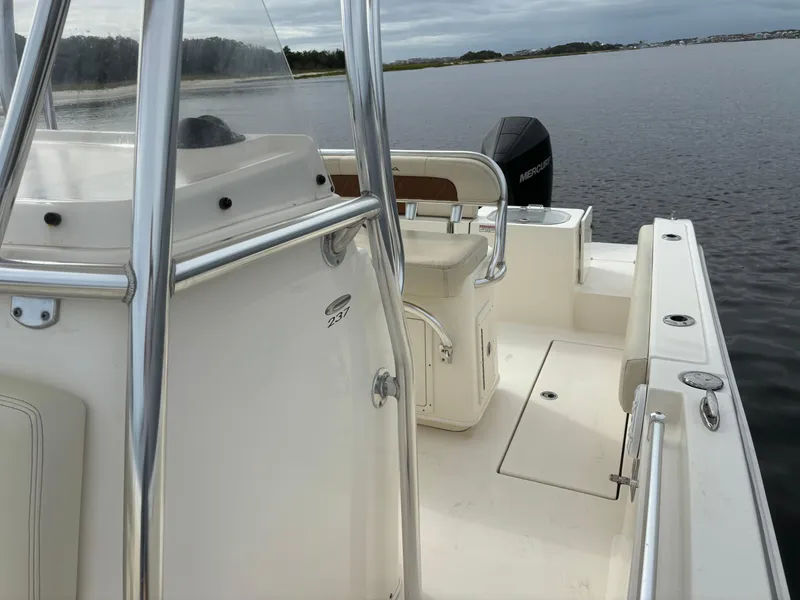 Slide: The Image of 2022 Cobia 237 Center Console boat on calm water, featuring sleek design and spacious deck. - 17