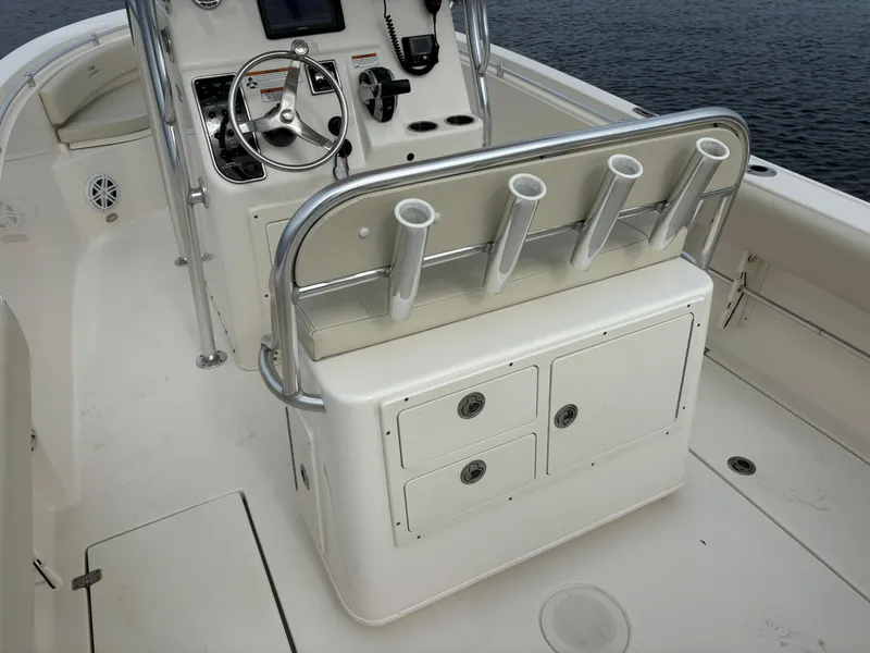Slide: The Image of 2022 Cobia 237 Center Console boat interior with steering wheel and rod holders. - 24