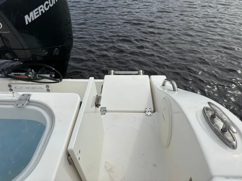 Slide: The Image of 2022 Cobia 237 Center Console boat with Mercury engine on water. - 31