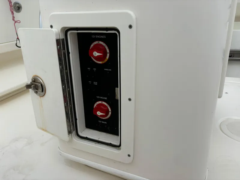 Slide: The Image of 2022 Cobia 237 Center Console battery switch panel with open access door. - 38