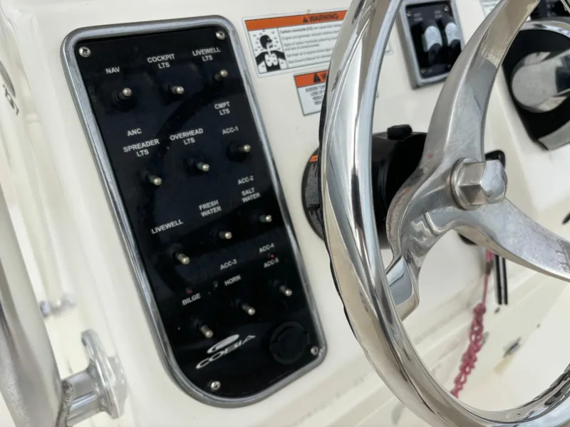 Slide: The Image of Close-up of 2022 Cobia 237 Center Console dashboard and steering wheel. - 40