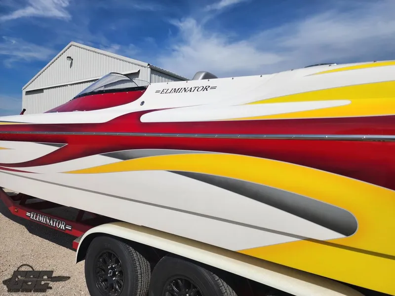 Slide: The Image of 2005 Eliminator Daytona 30 speedboat with vibrant red, yellow, and white design. - 11