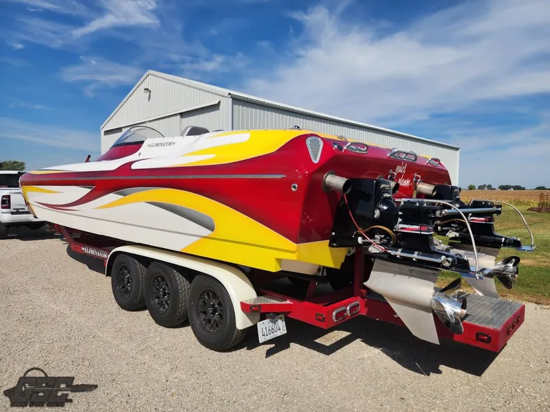 Slide: The Image of 2005 Eliminator Daytona 30 speedboat with vibrant red and yellow design on a trailer. - 15