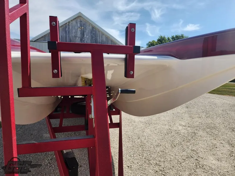 Slide: The Image of 2005 Eliminator Daytona 30 boat on red trailer, outdoor setting. - 16