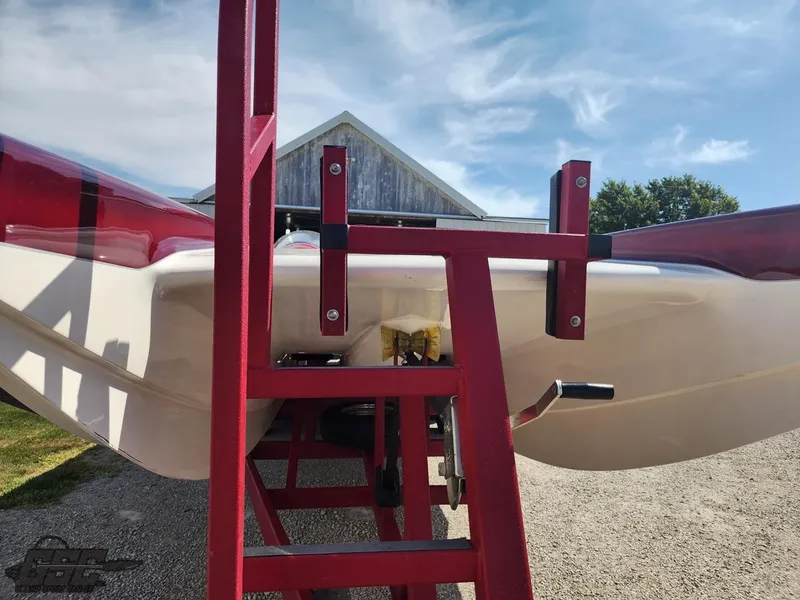 Slide: The Image of 2005 Eliminator Daytona 30 boat on red trailer, outdoor setting. - 17