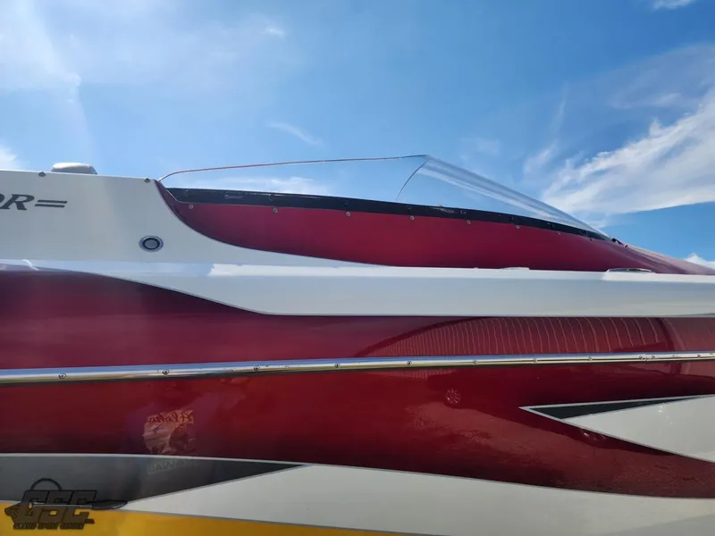Slide: The Image of Red and white 2005 Eliminator Daytona 30 boat against a clear blue sky. - 34