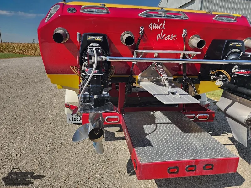 Slide: The Image of 2005 Eliminator Daytona 30 boat rear view with dual Mercury engines. - 38
