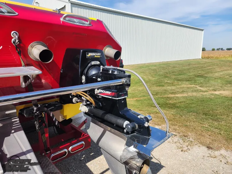 Slide: The Image of 2005 Eliminator Daytona 30 boat with Mercury engine, parked outdoors. - 43