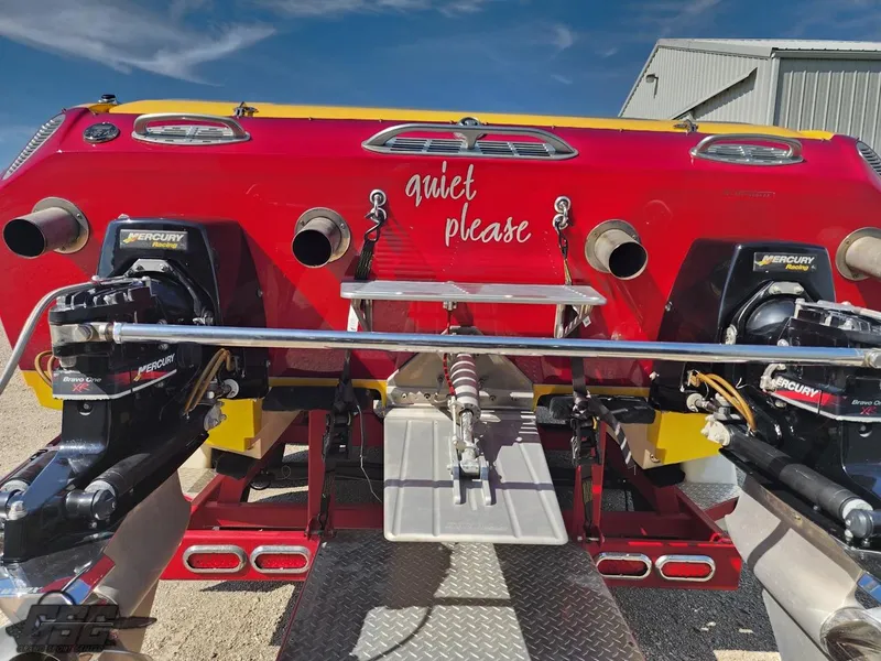 Slide: The Image of 2005 Eliminator Daytona 30 boat rear view with "quiet please" text, dual Mercury engines. - 44