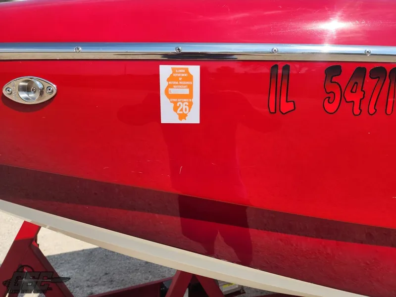 Slide: The Image of Red 2005 Eliminator Daytona 30 boat with registration number IL 5471, parked on a trailer. - 6