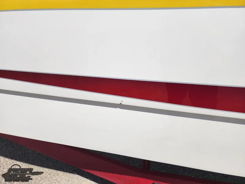 Slide: The Image of Close-up of 2005 Eliminator Daytona 30 boat hull with red and yellow accents. - 9
