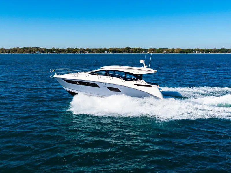 Slide: The Image of 2016 Sea Ray 400 Sundancer cruising on open water. - 10