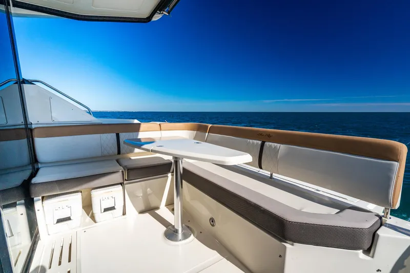 Slide: The Image of Sea Ray 400 Sundancer 2016 yacht deck with seating and ocean view. - 12