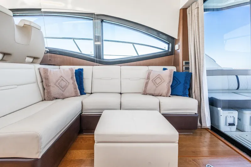 Slide: The Image of Luxurious interior of 2016 Sea Ray 400 Sundancer yacht with plush seating and cushions. - 14