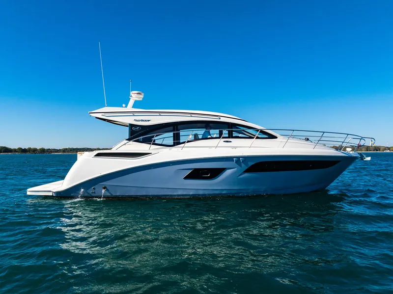 Slide: The Image of 2016 Sea Ray 400 Sundancer yacht cruising on open water. - 2