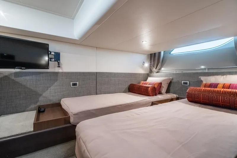 Slide: The Image of Luxurious cabin interior of 2016 Sea Ray 400 Sundancer yacht with twin beds and TV. - 28