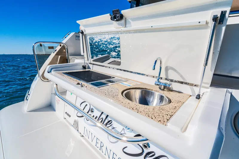 Slide: The Image of Sea Ray 400 Sundancer 2016 yacht with outdoor sink and grill on deck. - 29