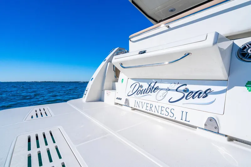 Slide: The Image of Sea Ray 400 Sundancer 2016 boat, "Double Seas," on water, clear blue sky. - 30